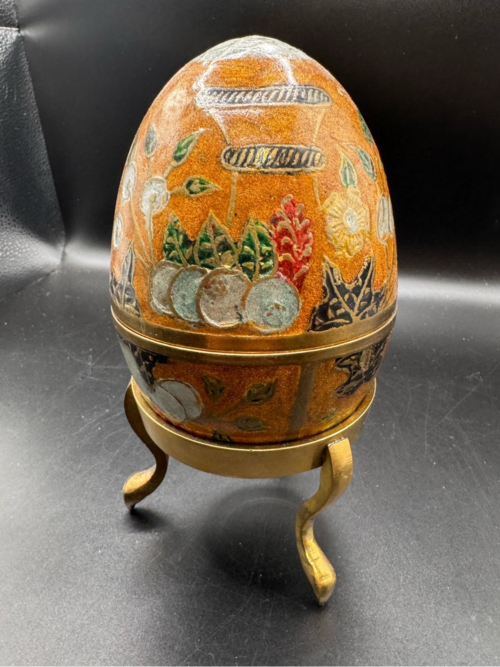Vintage enameled brass cloisonné egg trinket box on a matching three-legged bras